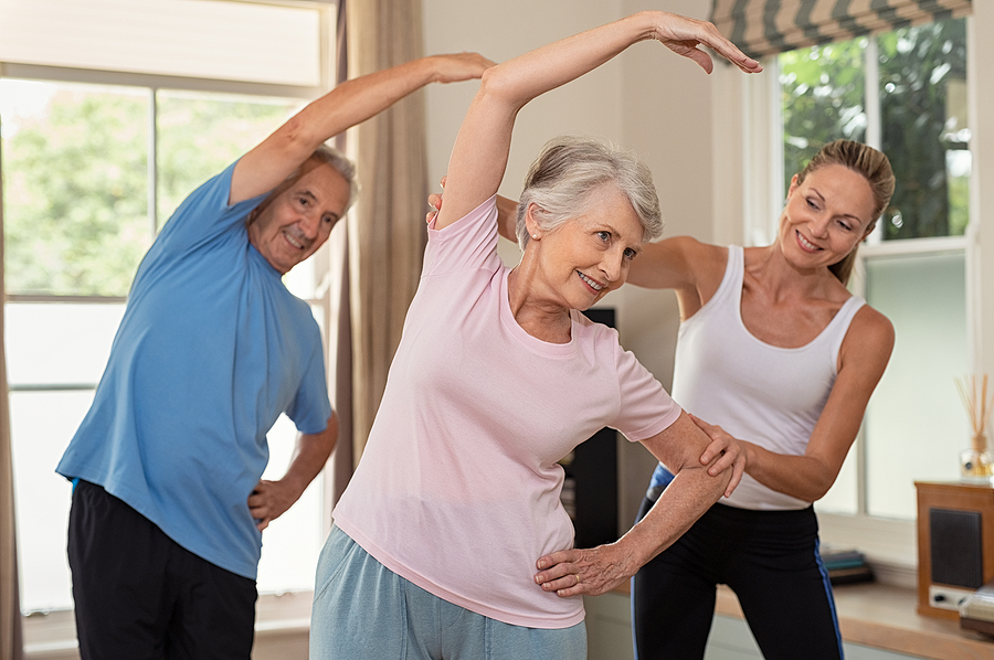 Senior couple doing exercises to support mobility and manage ankylosing spondylitis symptoms.