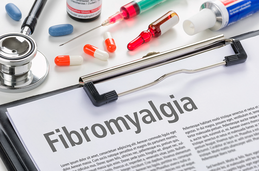 Living with fibromyalgia begins with a diagnosis, shown written on a clipboard
